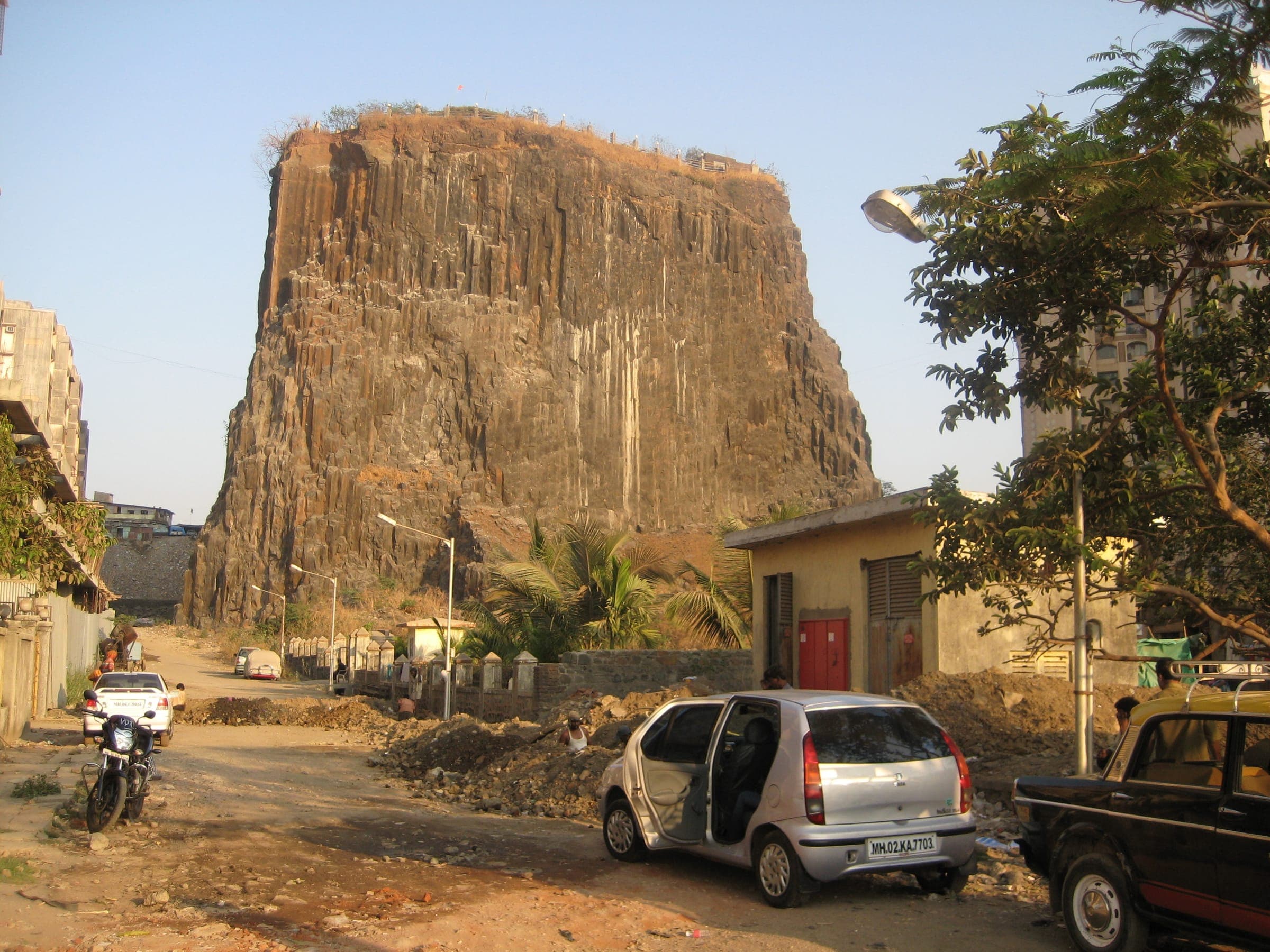 Gilbert Hill, a sheer column of black basalt, rising above an Andheri lane