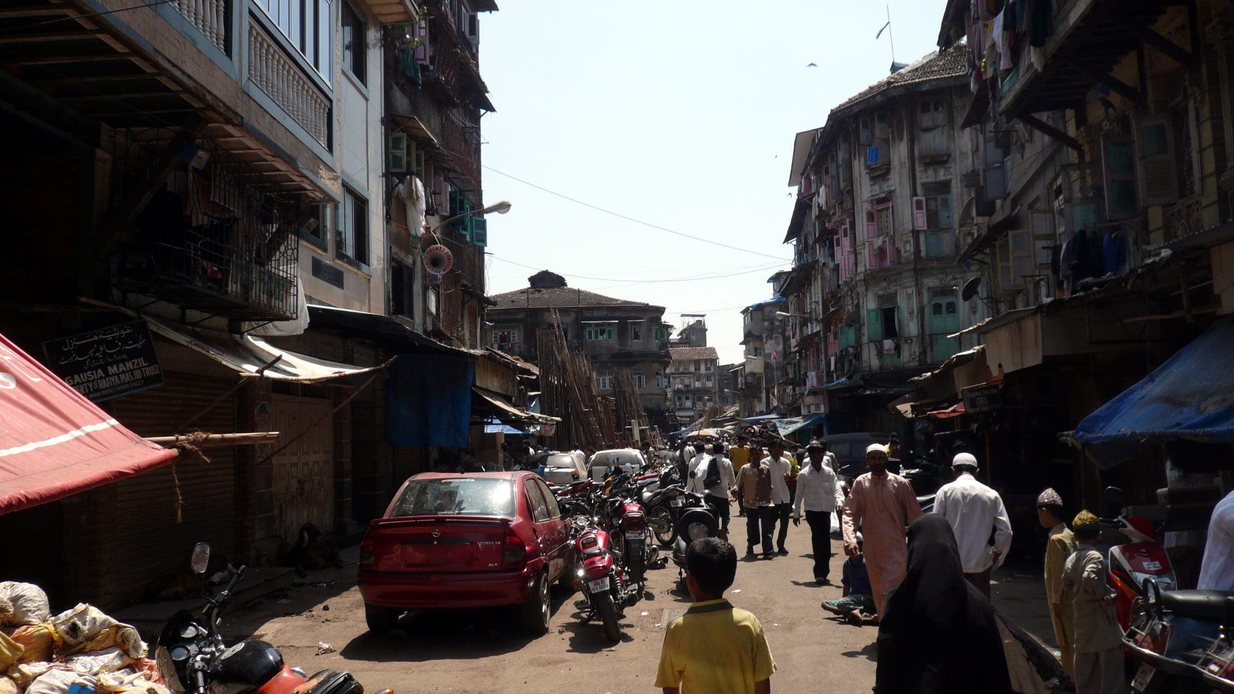 A crowded lane of old buildings and shopfronts in Chor Bazaar