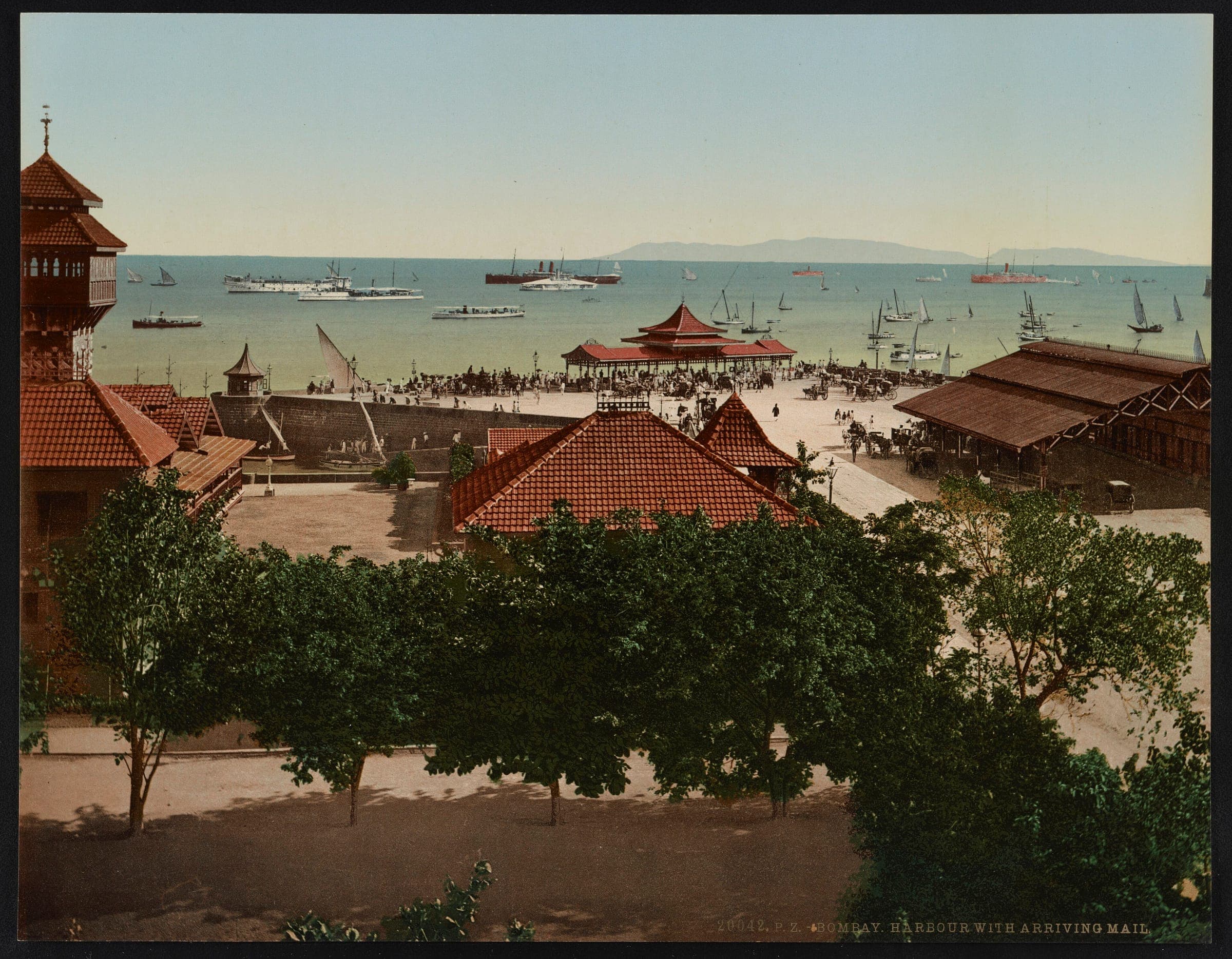 Bombay harbour in the 1890s seen over red-tiled roofs, with the mail steamer arriving