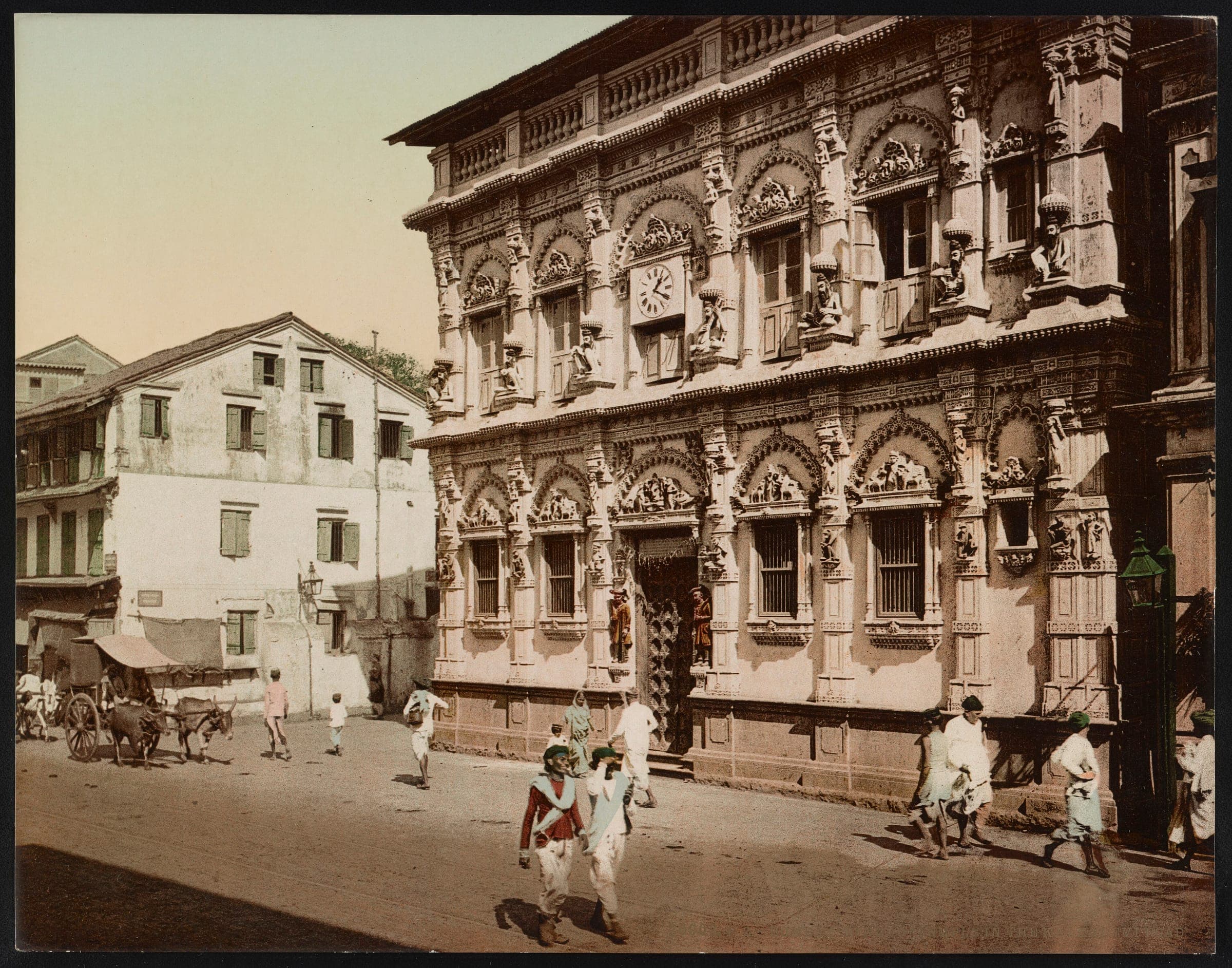 A richly carved temple front on Kalbadevi Road in the 1890s, with people passing in the street