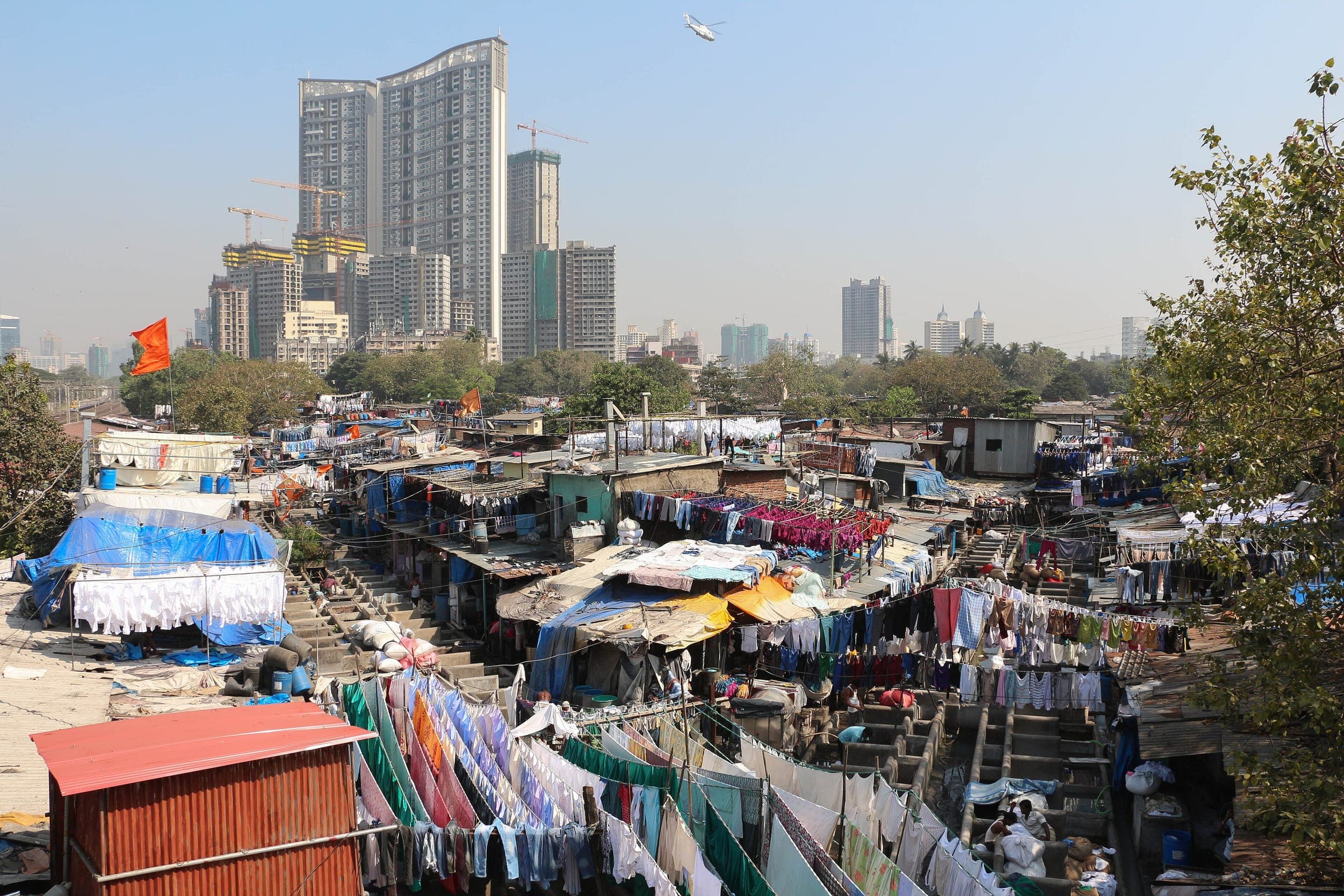 Washing lines and wash pens at Dhobi Ghat with towers rising behind