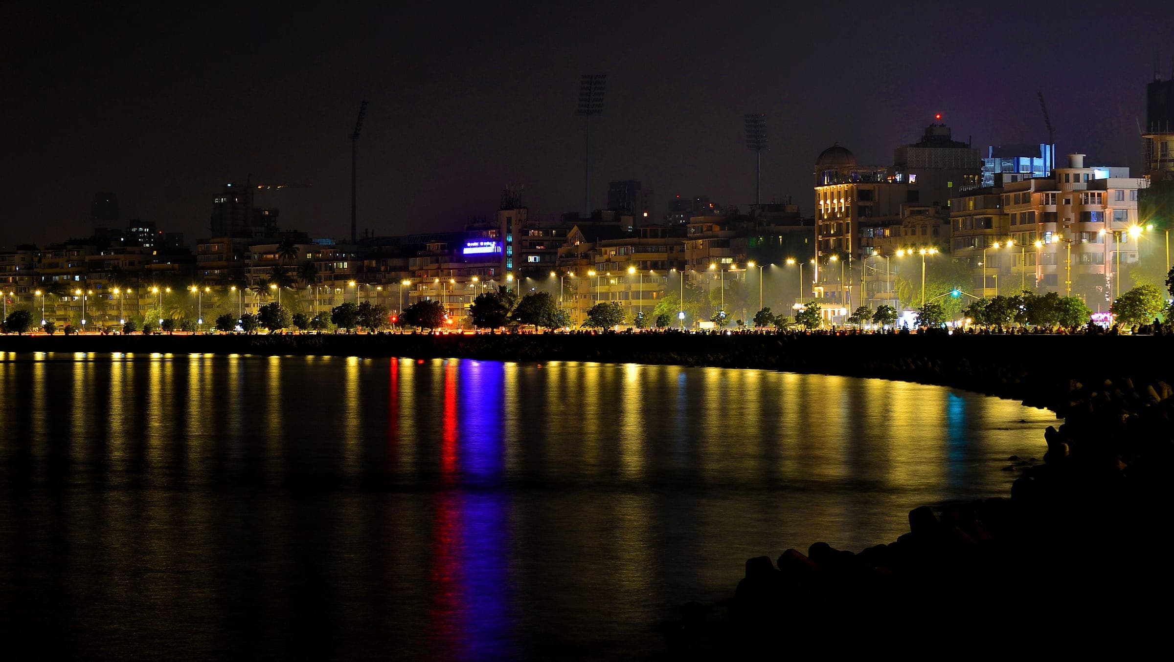 Street lamps along Marine Drive reflected in the bay at night