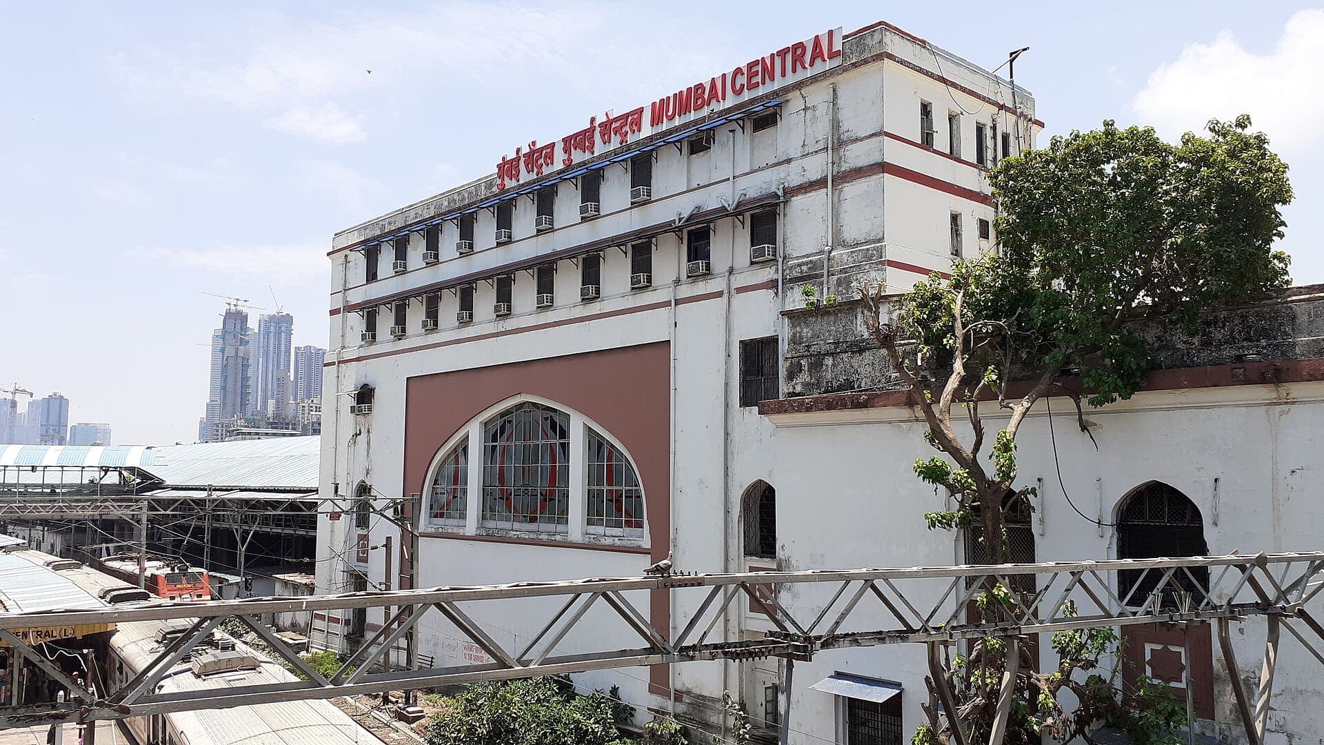 The white and maroon main building of Mumbai Central station seen from the west, with its name along the roof